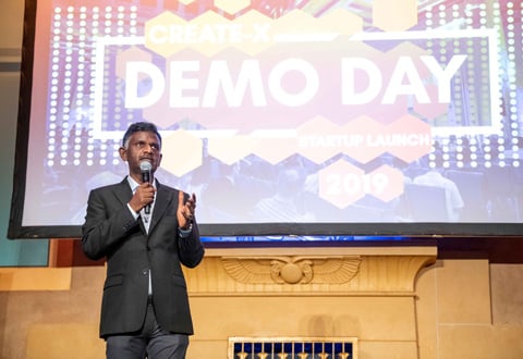 Photo of man giving a presentation to a crowd